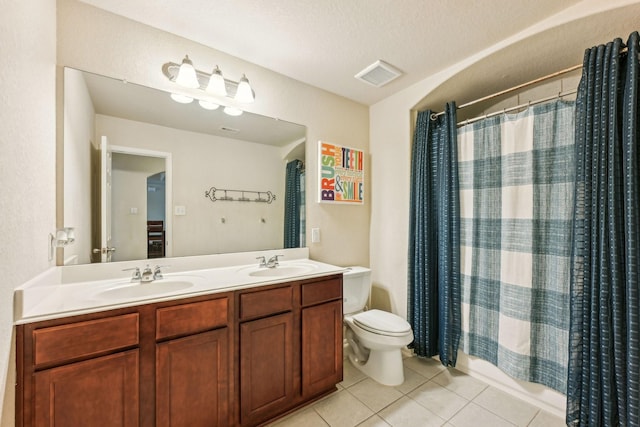 full bathroom featuring a textured ceiling, tile patterned floors, vanity, shower / bath combination with curtain, and toilet