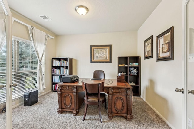 carpeted home office featuring plenty of natural light and french doors