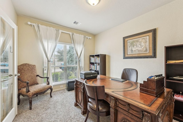 carpeted home office with french doors