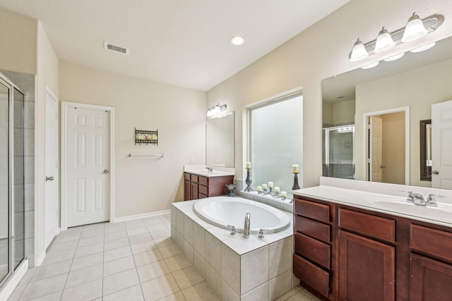 bathroom with vanity, tile patterned flooring, and plus walk in shower