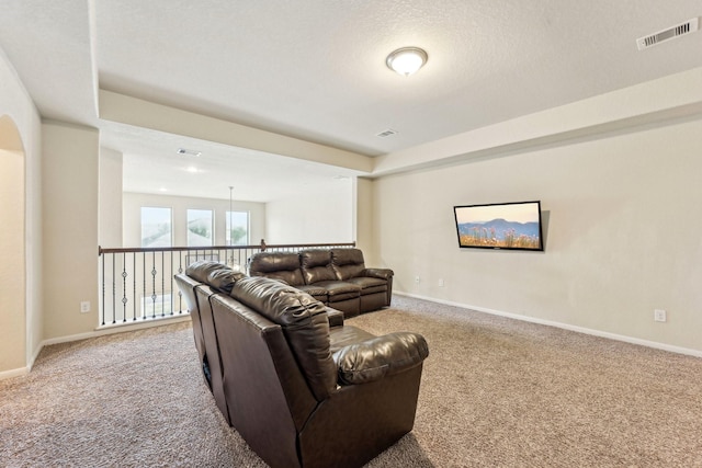 carpeted living room with a textured ceiling