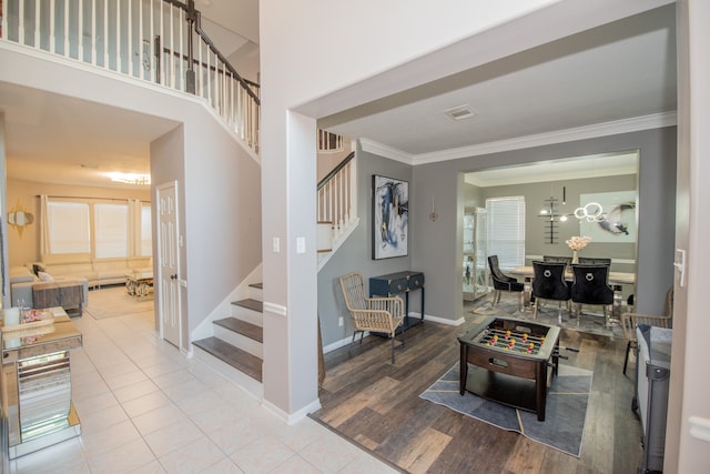 living room featuring crown molding, hardwood / wood-style flooring, and a chandelier