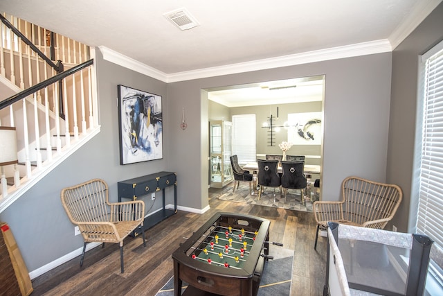 living room featuring dark wood-type flooring and ornamental molding