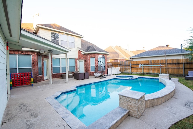 view of swimming pool with an in ground hot tub and a patio area