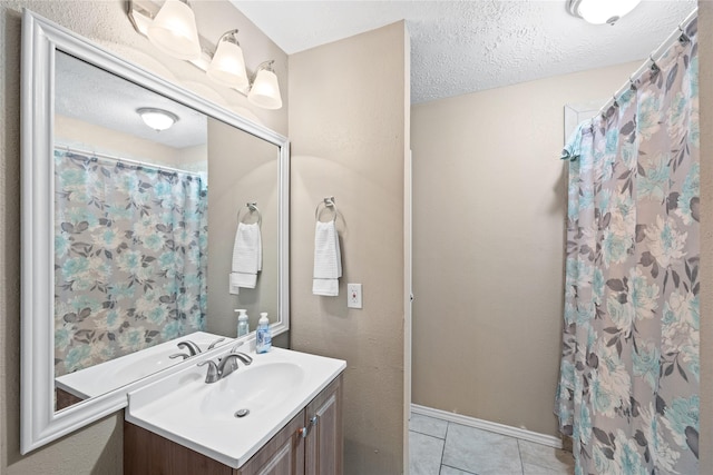 bathroom featuring tile patterned floors, vanity, a textured ceiling, and a shower with shower curtain