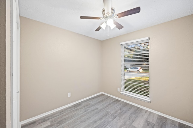 unfurnished room with ceiling fan and light hardwood / wood-style flooring