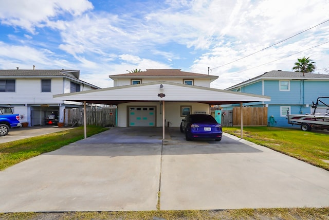 view of front facade featuring a front yard, a garage, and a carport