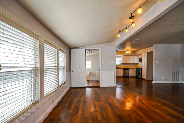 unfurnished living room featuring a textured ceiling, lofted ceiling, and dark hardwood / wood-style floors