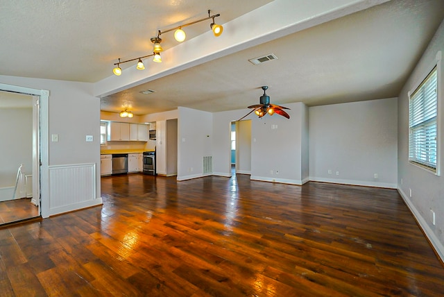 unfurnished living room featuring ceiling fan, a textured ceiling, and dark hardwood / wood-style floors