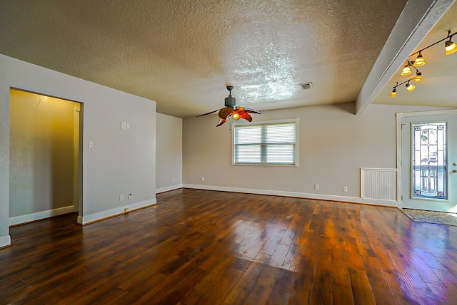 unfurnished room featuring ceiling fan, lofted ceiling with beams, a textured ceiling, and dark hardwood / wood-style flooring