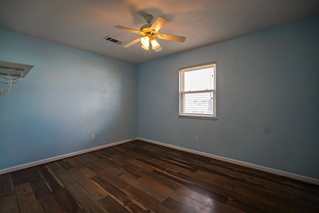 spare room with ceiling fan and dark hardwood / wood-style flooring