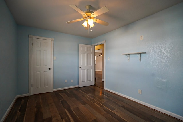 unfurnished bedroom with dark wood-type flooring and ceiling fan