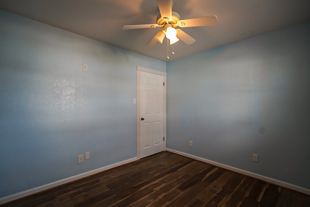 spare room with dark hardwood / wood-style floors and ceiling fan