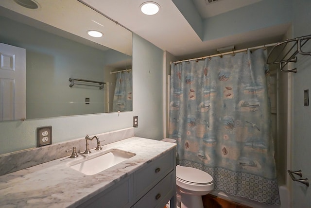 full bathroom with vanity, shower / tub combo with curtain, and toilet