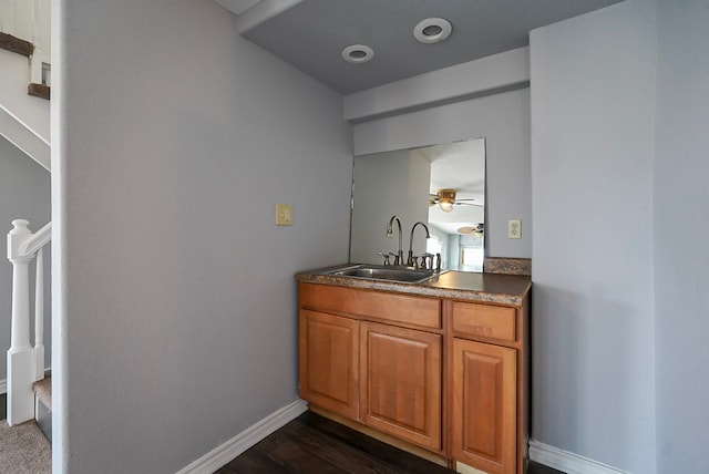 bar with sink and dark wood-type flooring