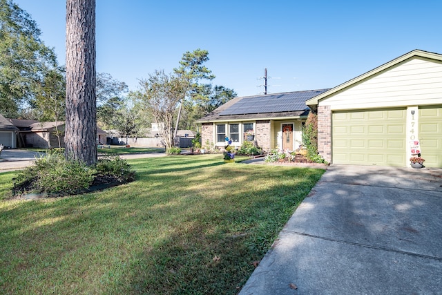 ranch-style home featuring a garage, a front lawn, and solar panels