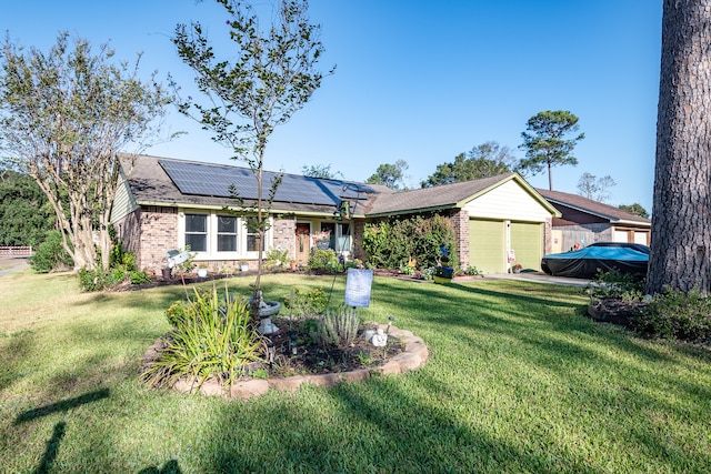 ranch-style home with a front yard, solar panels, and a garage