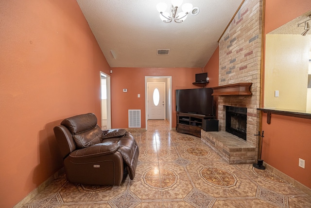 living room with an inviting chandelier, a brick fireplace, a textured ceiling, and high vaulted ceiling