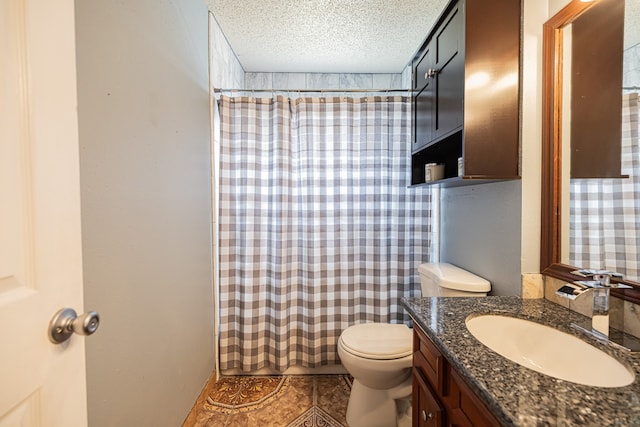 bathroom featuring vanity, a shower with shower curtain, a textured ceiling, and toilet