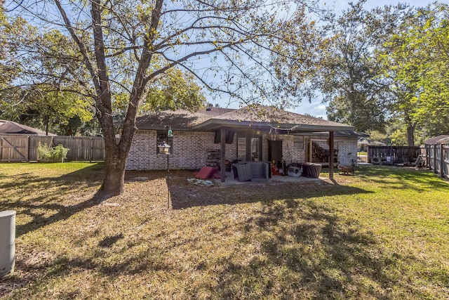 rear view of house with a patio area and a lawn