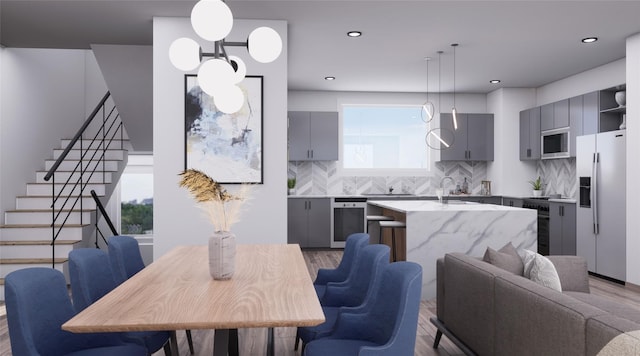 interior space featuring a wealth of natural light, sink, and light hardwood / wood-style flooring