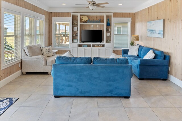 tiled living room with wood walls, ornamental molding, and plenty of natural light