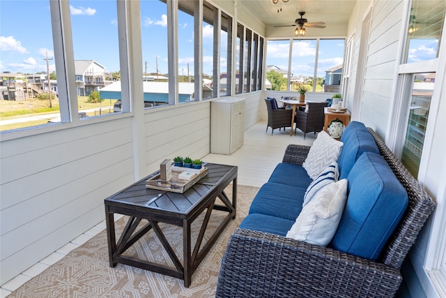 sunroom featuring ceiling fan