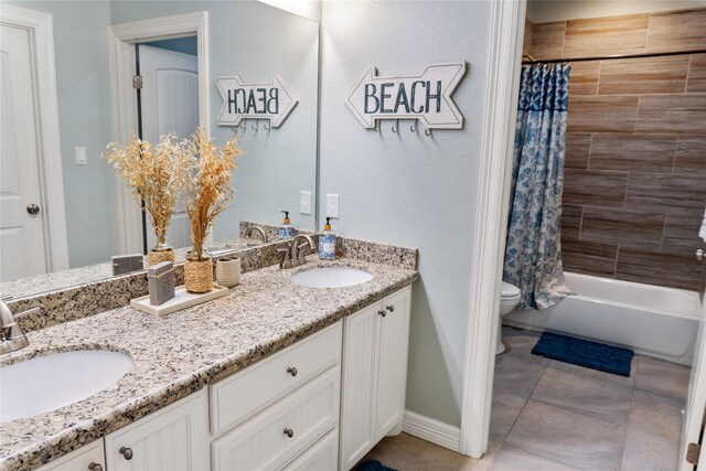 full bathroom featuring toilet, vanity, shower / bathtub combination with curtain, and tile patterned floors