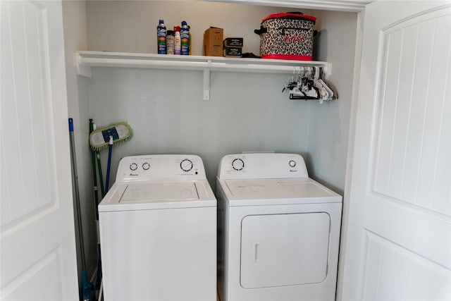 washroom with washing machine and clothes dryer and laundry area