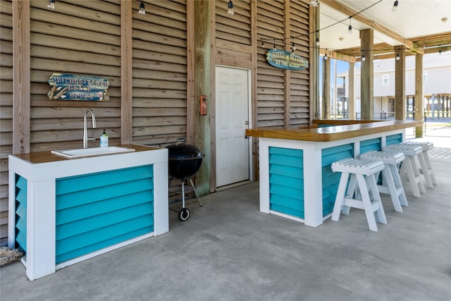 view of patio with an outdoor wet bar