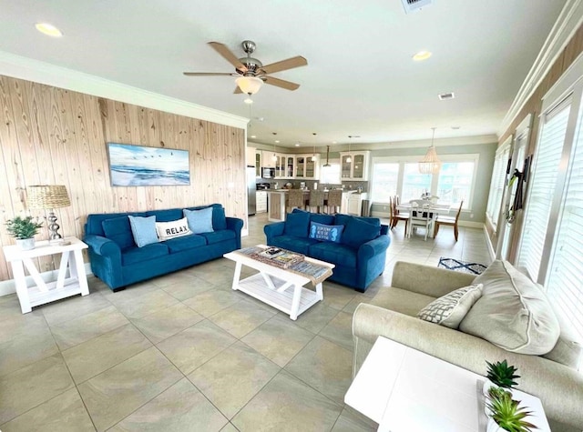 living room with visible vents, crown molding, wood walls, recessed lighting, and a ceiling fan