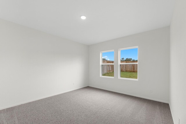 carpeted spare room with recessed lighting and baseboards