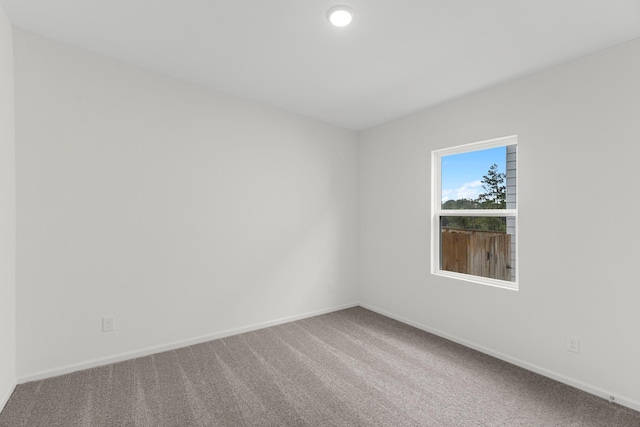 spare room with carpet floors, recessed lighting, and baseboards