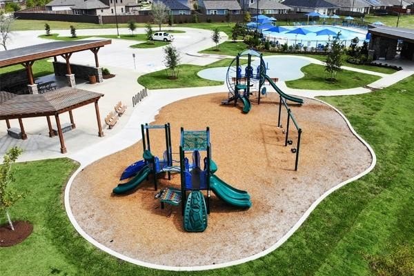 view of home's community featuring a lawn and a playground