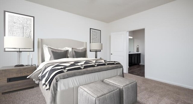 carpeted bedroom featuring baseboards and ensuite bathroom