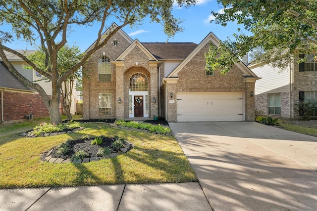 traditional-style home with brick siding, a garage, concrete driveway, and a front lawn