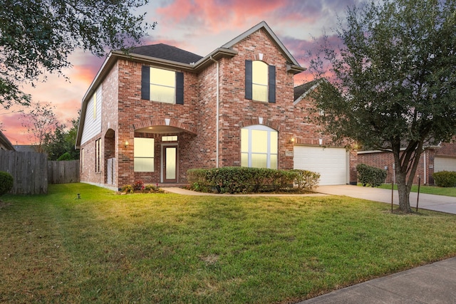 view of front property with a yard and a garage