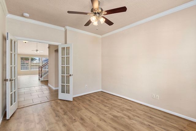 empty room featuring light hardwood / wood-style flooring, french doors, a textured ceiling, and crown molding