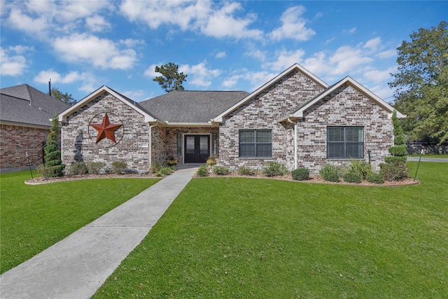 view of front facade featuring a front yard and french doors