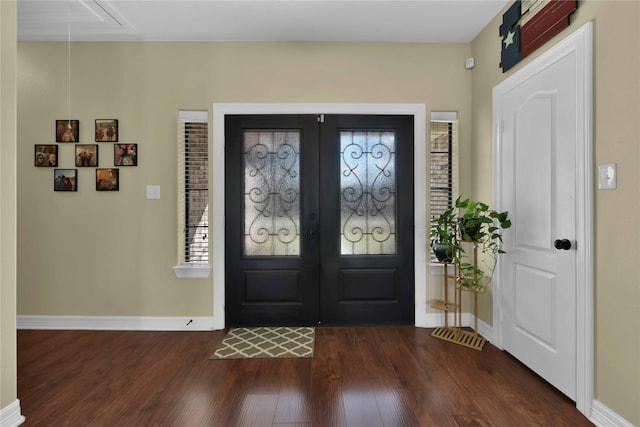 foyer entrance with french doors and dark hardwood / wood-style floors