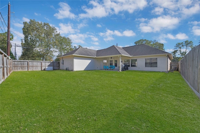 rear view of house with a patio and a lawn