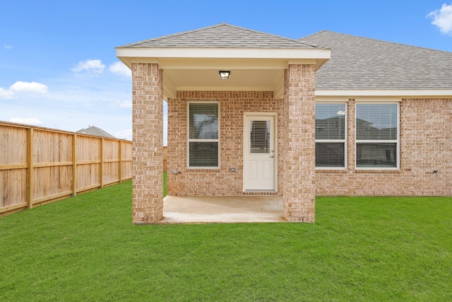 rear view of property with a patio area and a lawn