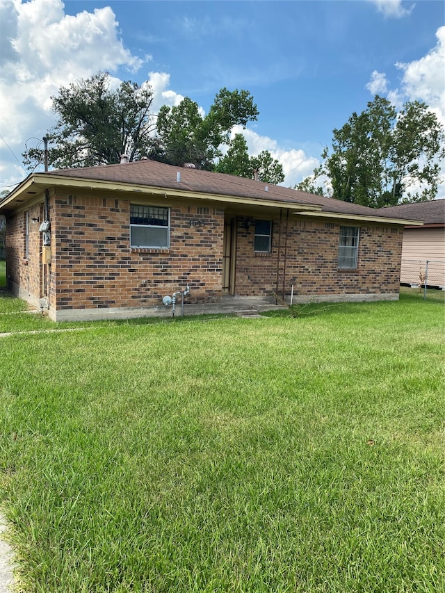 rear view of property with a lawn