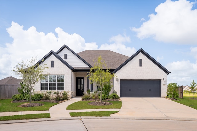 view of front of house with a garage and a front lawn