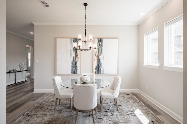 dining area with crown molding, dark hardwood / wood-style floors, and a chandelier