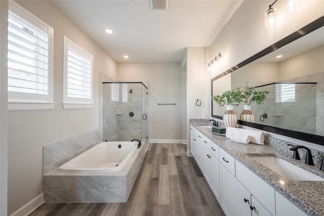 bathroom with vanity, hardwood / wood-style flooring, and separate shower and tub