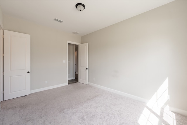 unfurnished room with light carpet