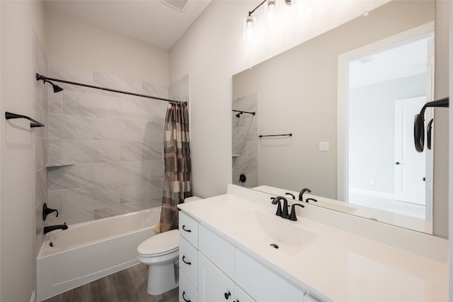 full bathroom featuring vanity, hardwood / wood-style floors, shower / bath combo with shower curtain, and toilet