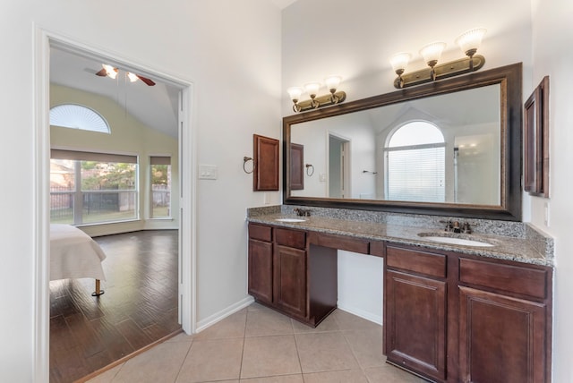 bathroom featuring vanity, hardwood / wood-style flooring, ceiling fan, and vaulted ceiling