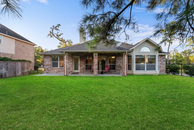 back of house featuring a yard and a patio area